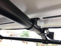 The tent's mounting rail bolted to the rack tube, seen from under the open tent