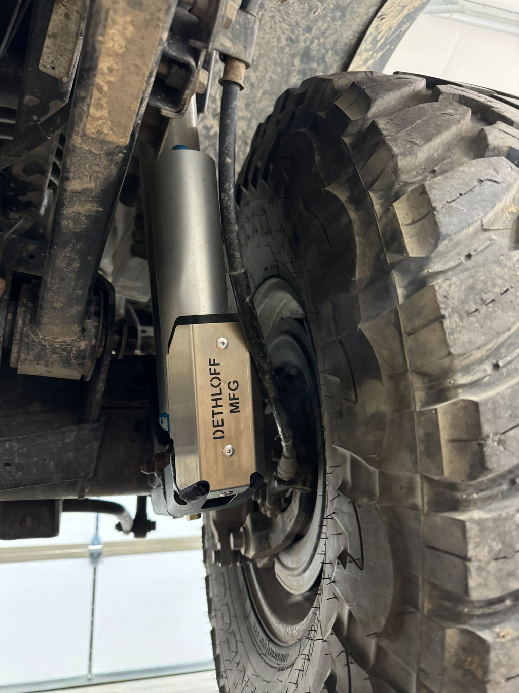 The fitted guard seen past the rear tire in the shop