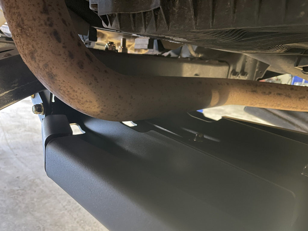 The fitted plate seen along the underside of the truck with the exhaust running above it