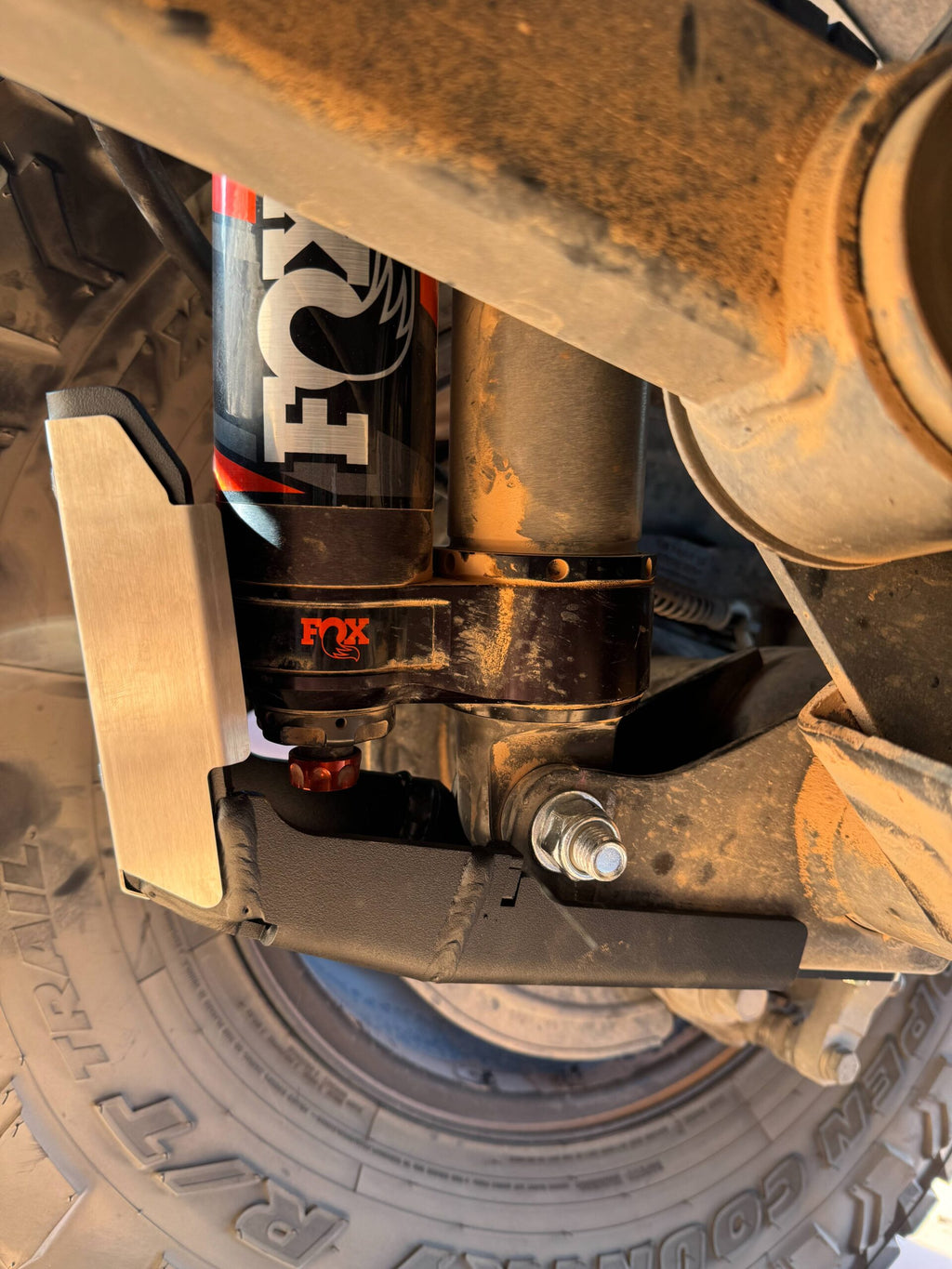 The guard shielding the lower body of a Fox shock, seen from under the axle