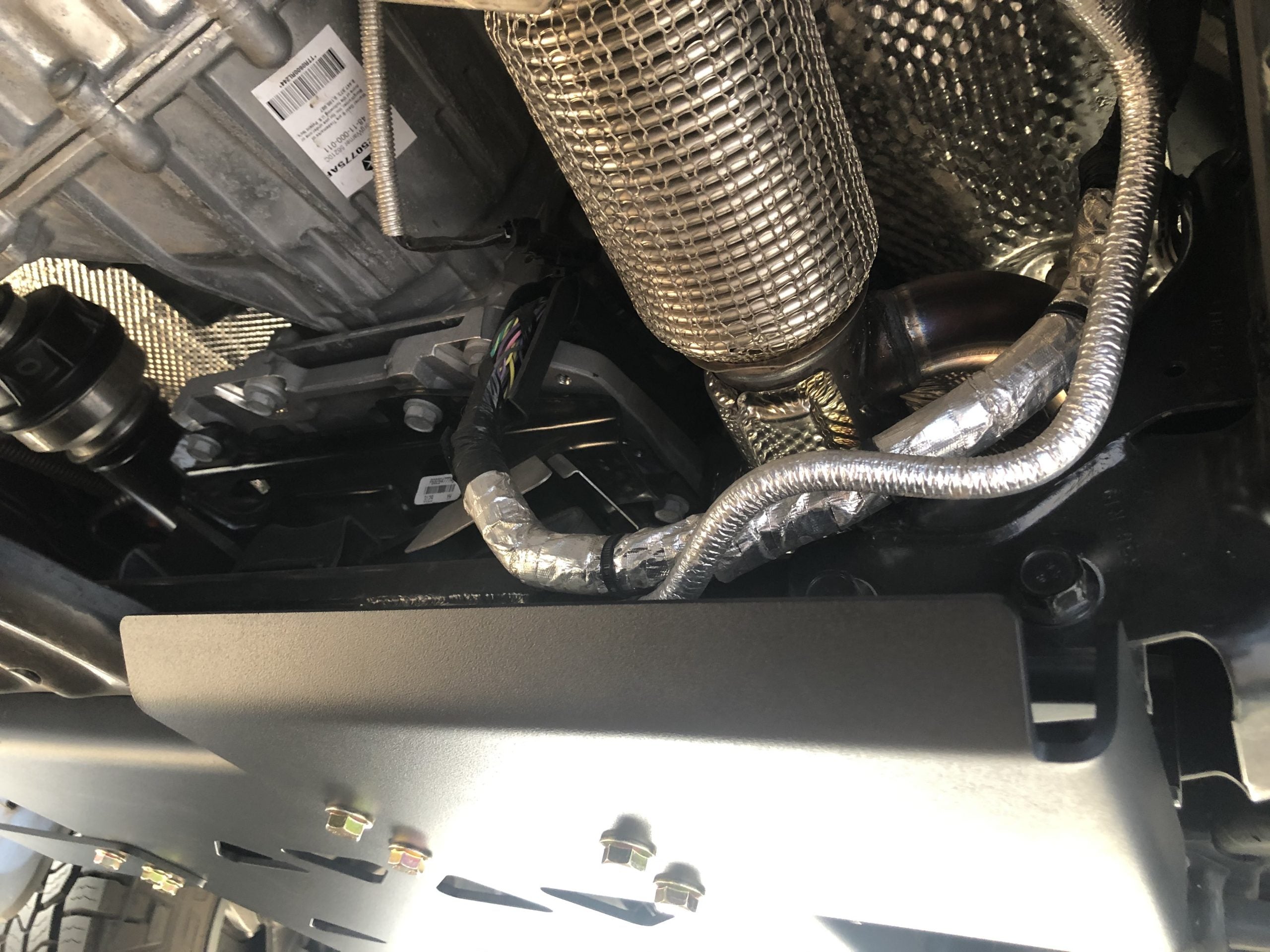 The fitted plate below the exhaust and heat shielding, seen from underneath