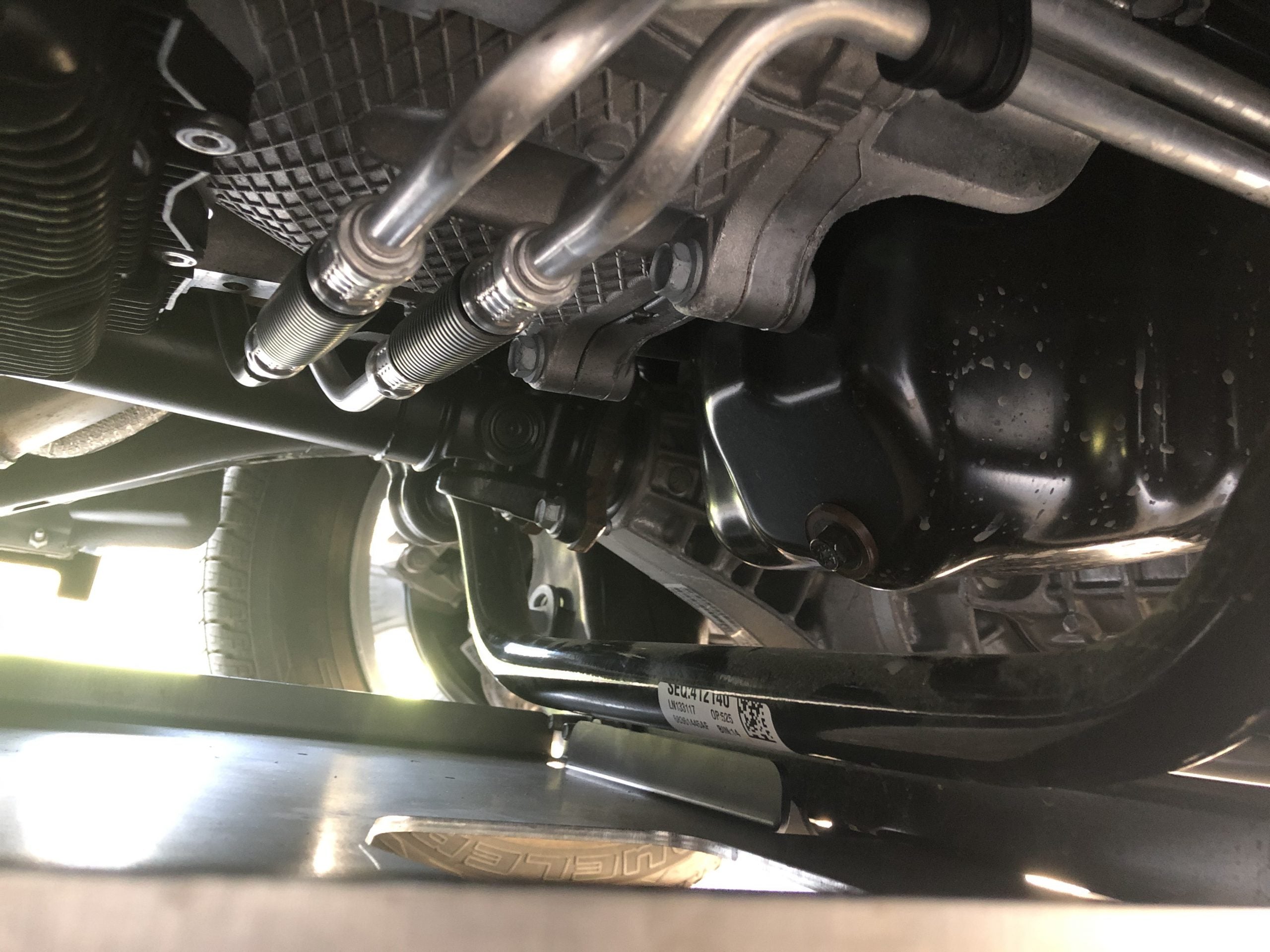 Front differential and axle shafts above the fitted plate, seen from below