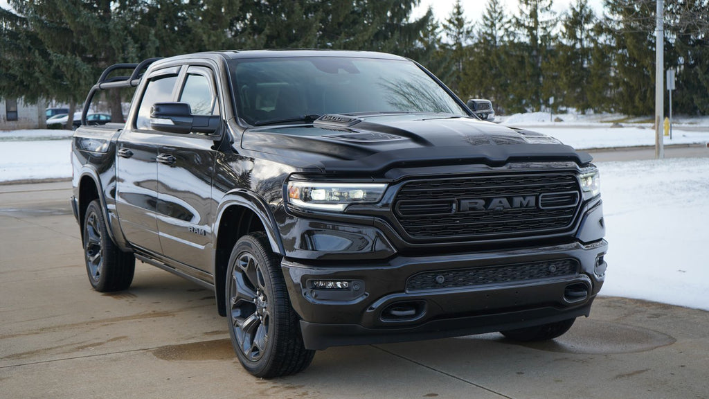 Front quarter of the black Ram 1500 from the opposite side, rack behind the cab