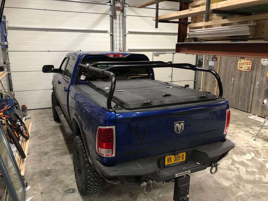 Blue Ram in a garage, rack fitted over a hard folding tonneau cover