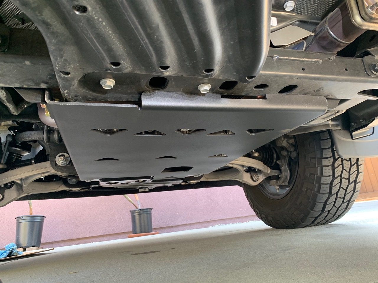 The fitted plate looking straight up from under the truck, front tire off to the right