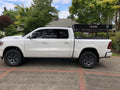 White Ram 1500 on a brick driveway, a closed roof tent mounted on the bed rack