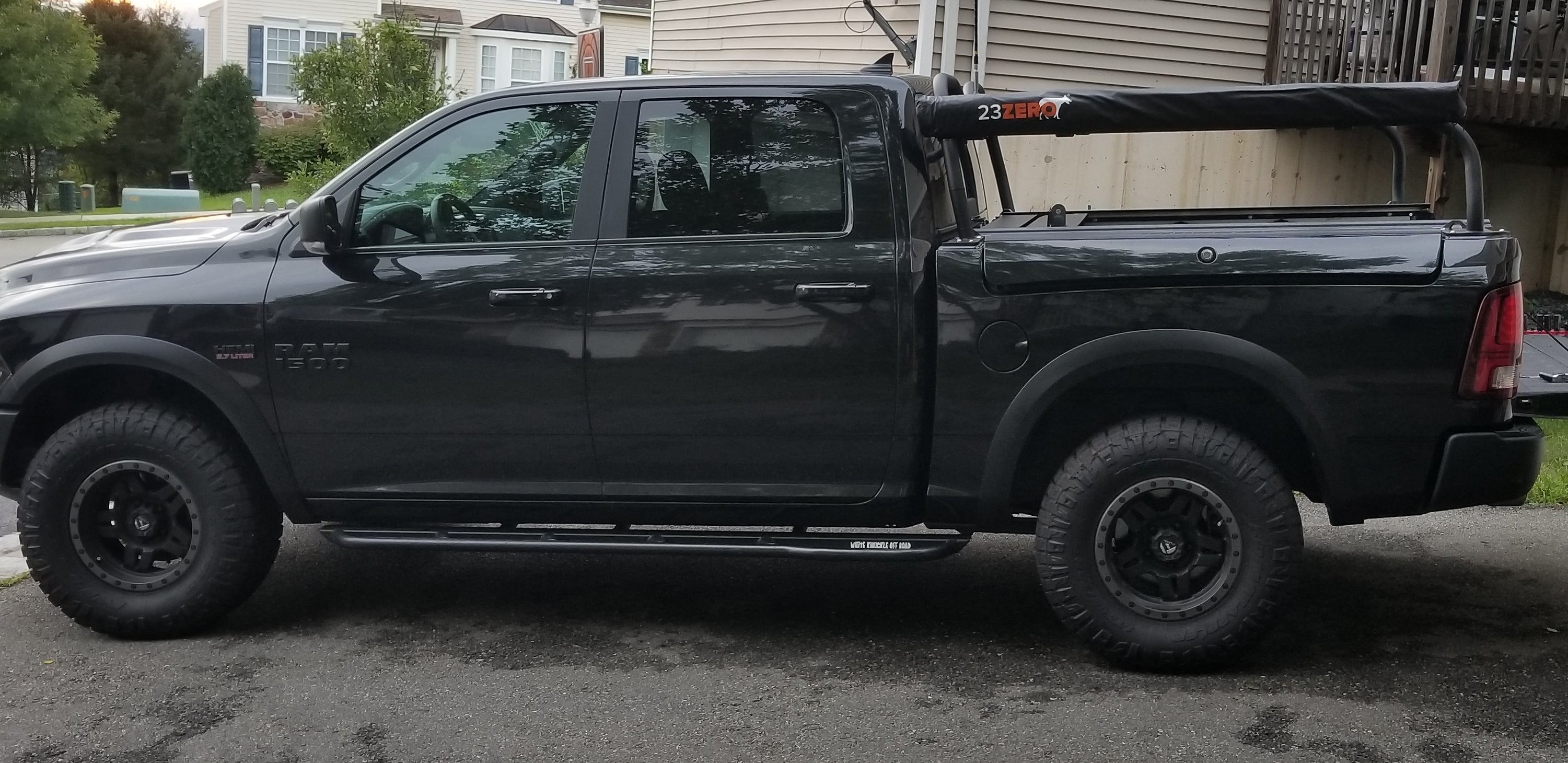 Side view of the black Ram, awning mounted the length of the bed