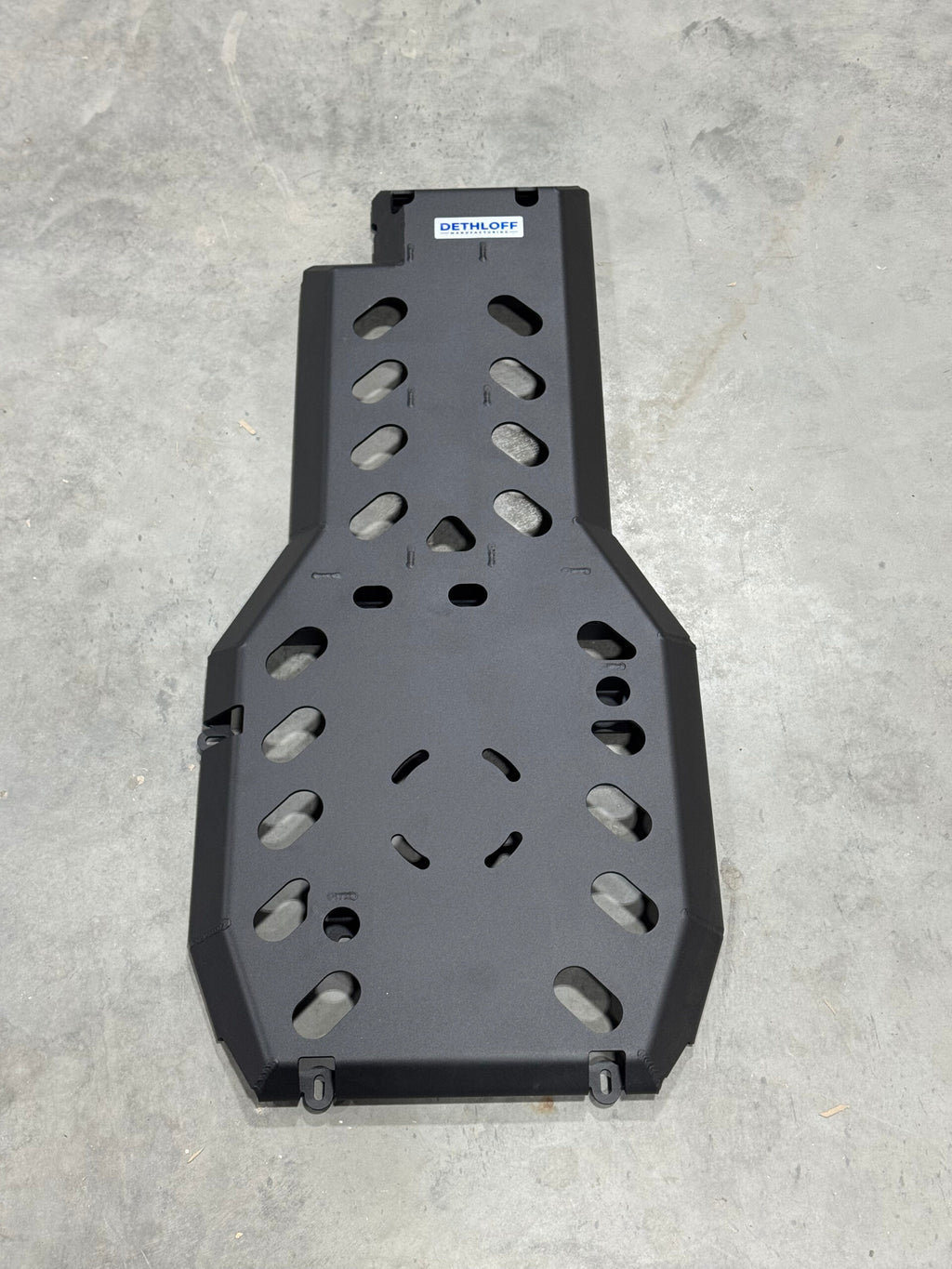 The bare guard on a concrete floor seen from above, lightening holes and the Dethloff badge