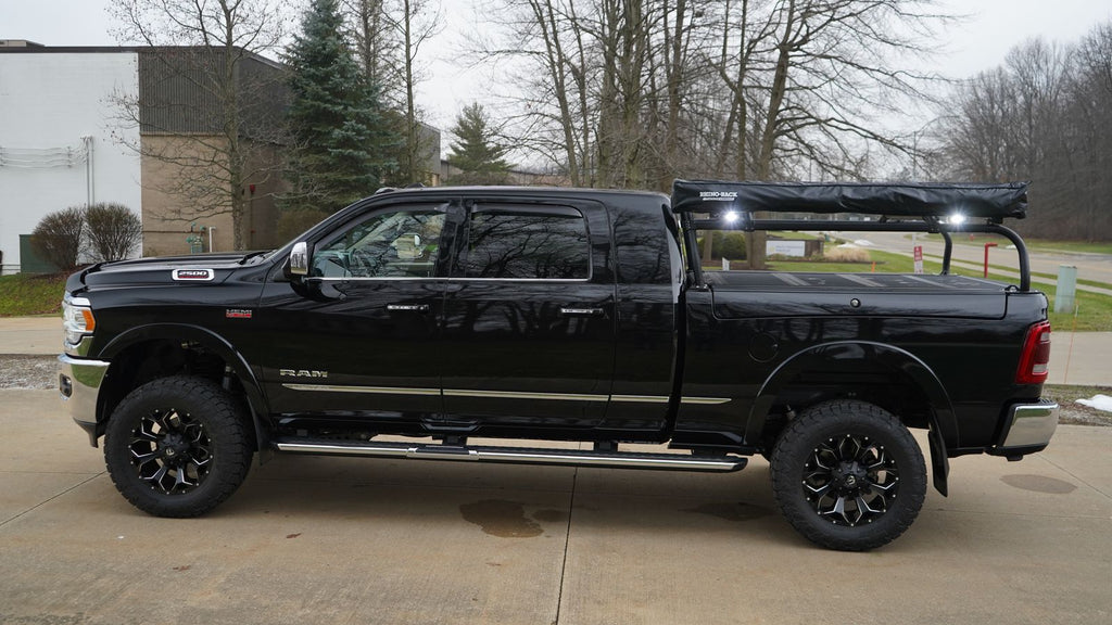 Full side view of the black Ram, rack lights facing forward over the cab