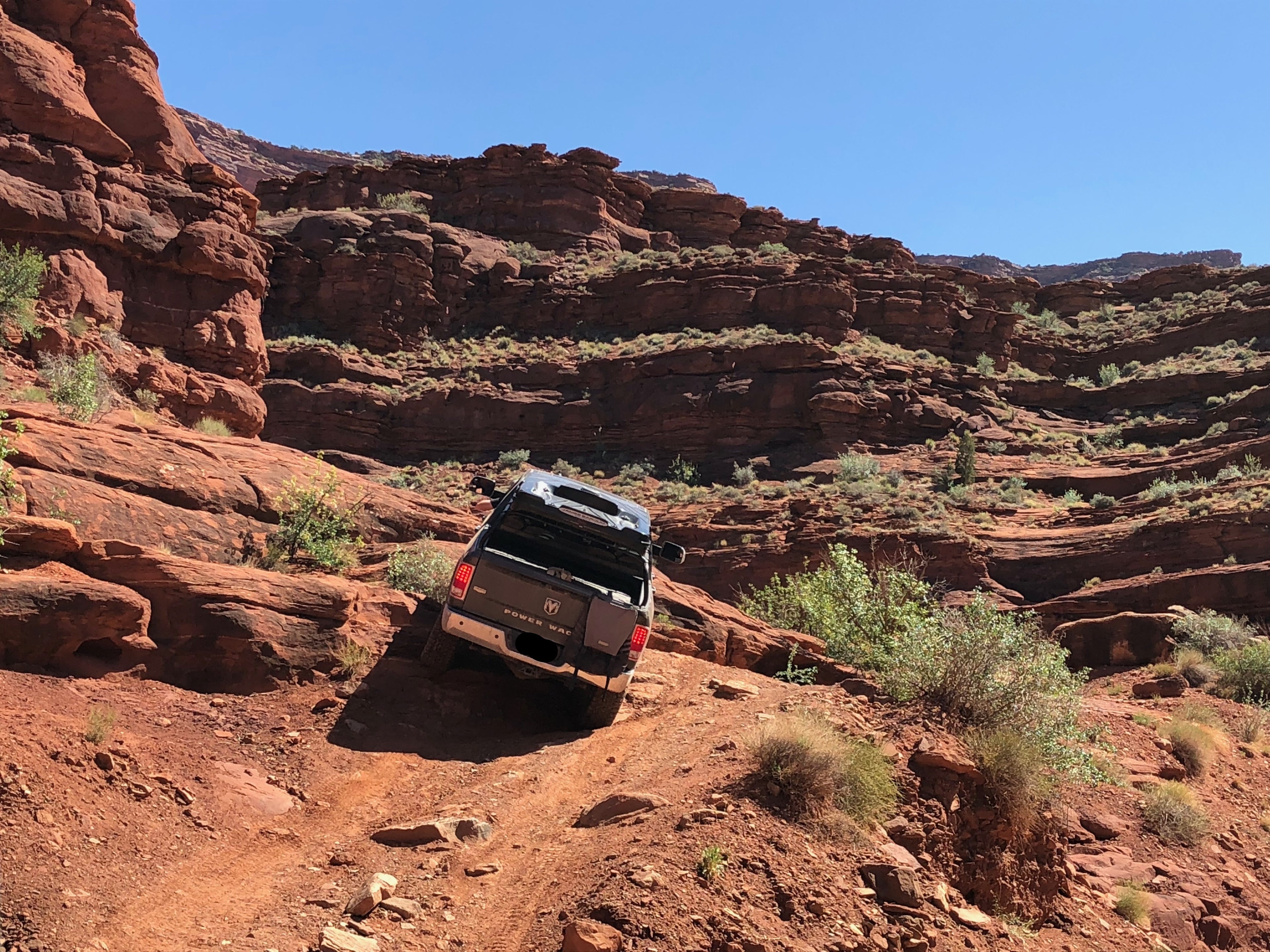 The Power Wagon climbing a steep rock ledge, seen from a distance