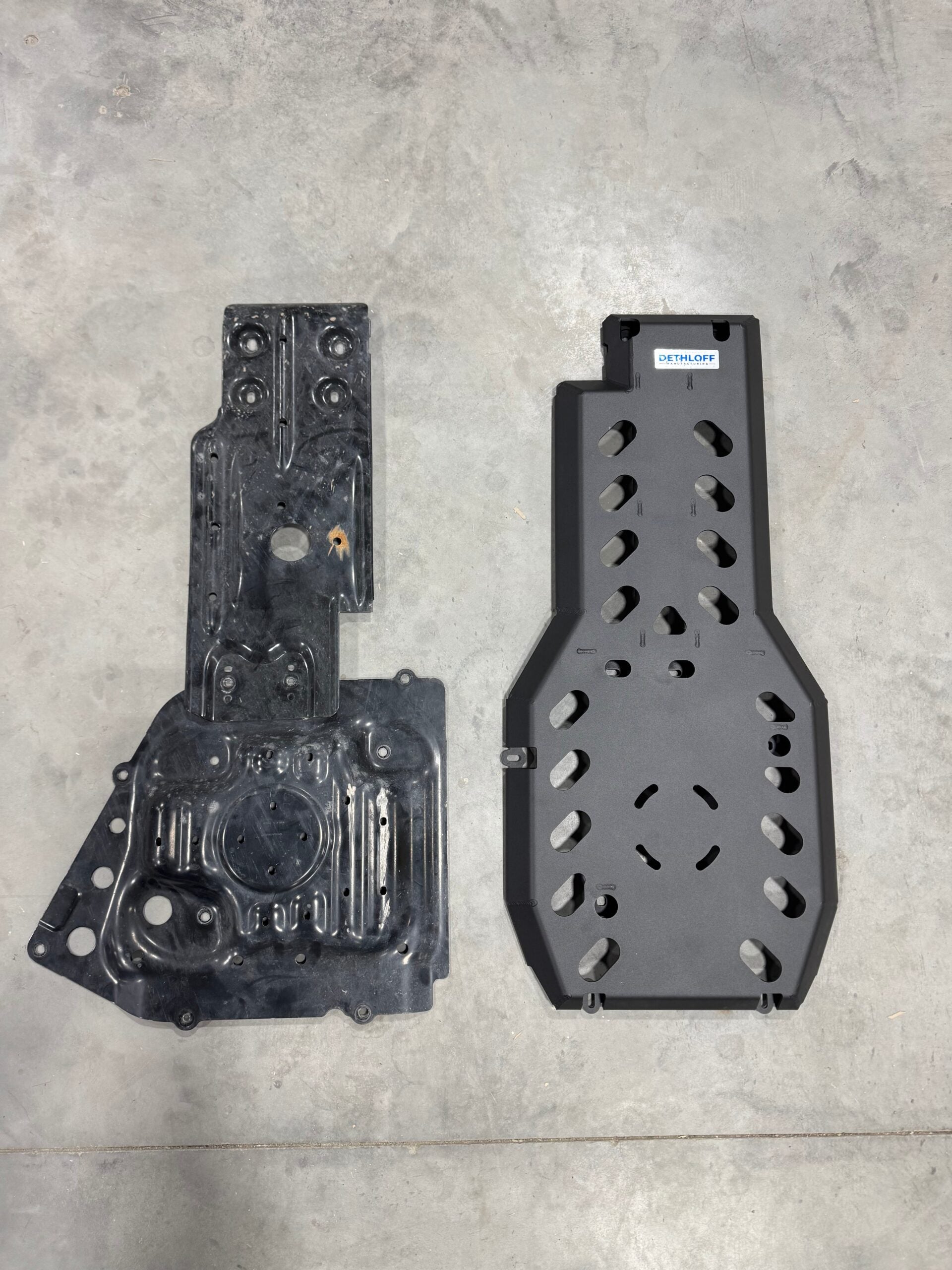 The stock plastic under-cover laid beside the steel guard on the floor for comparison