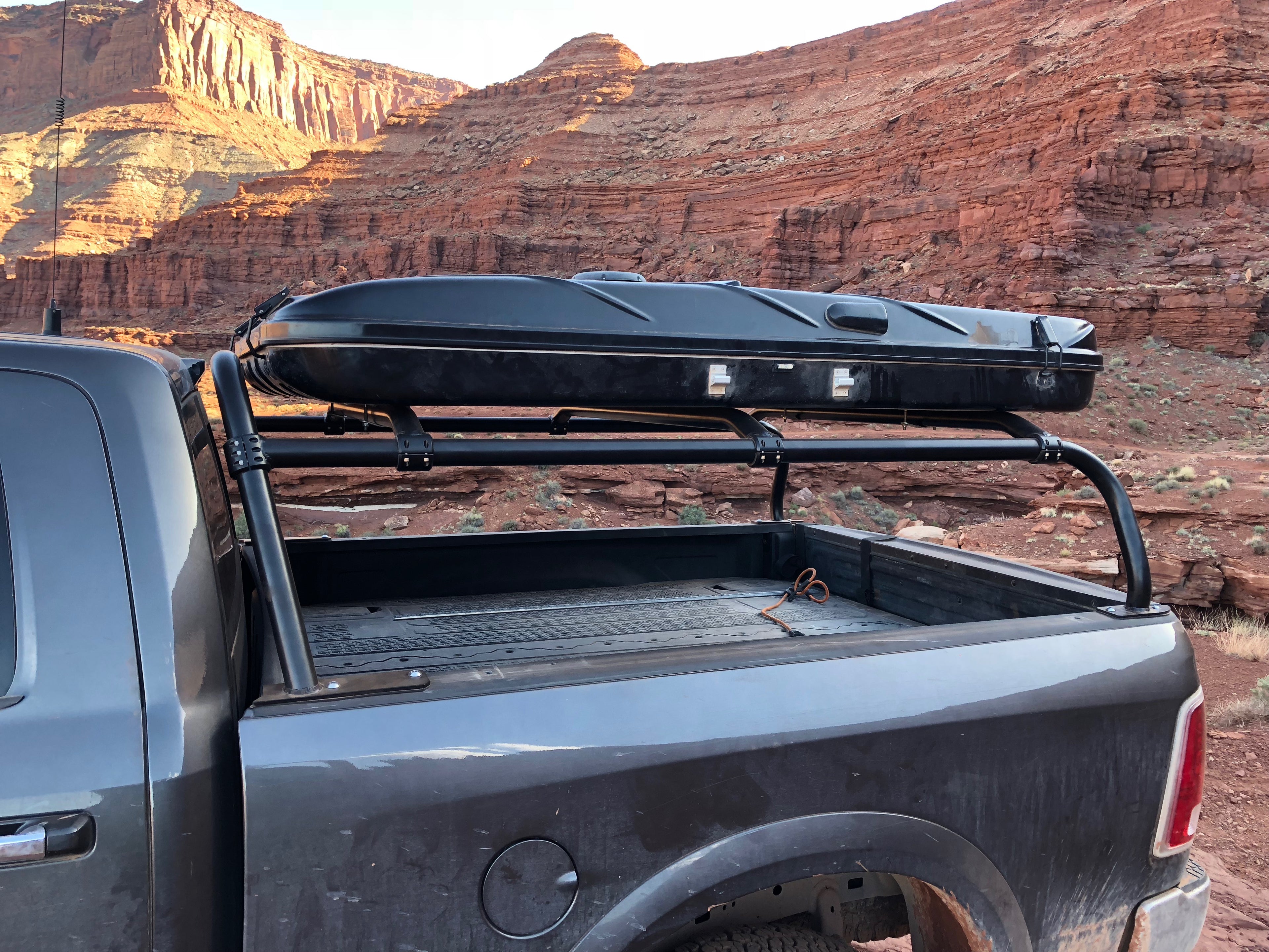 Roof box on the rack seen from the rear quarter, canyon walls behind