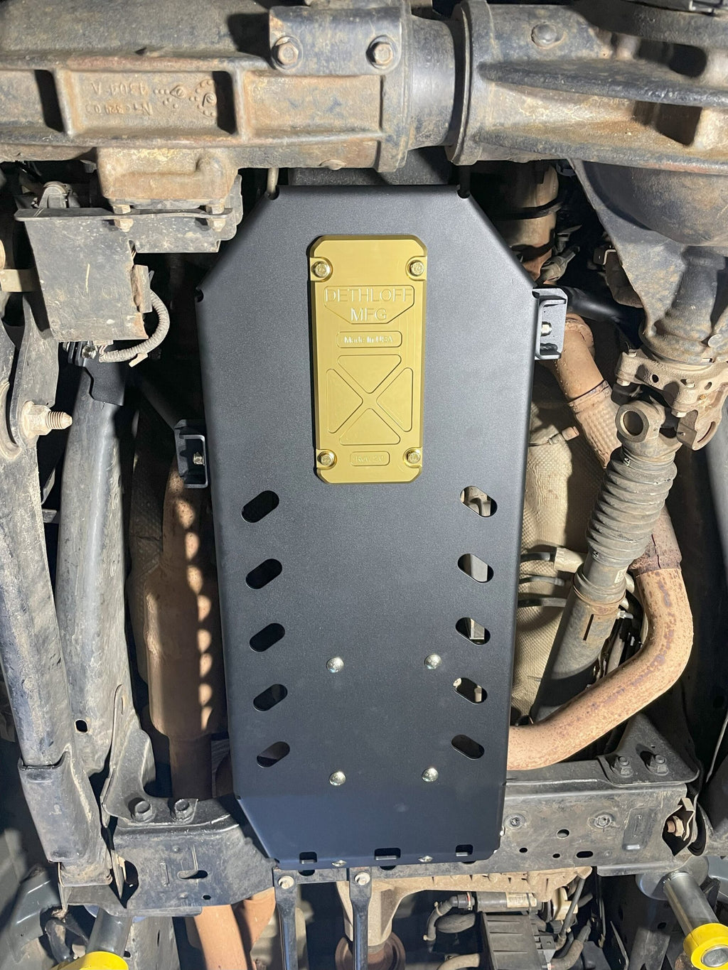 Looking straight up at the fitted plate with its gold service panel and drain slots