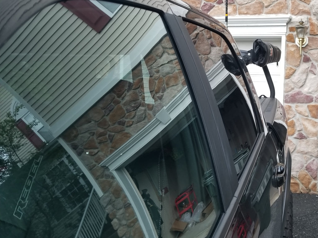 The mounted awning seen along the cab window, bracket up at the roofline
