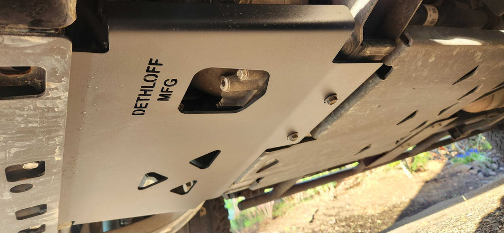 The fitted plate from below, its cutouts and stamped badge in view
