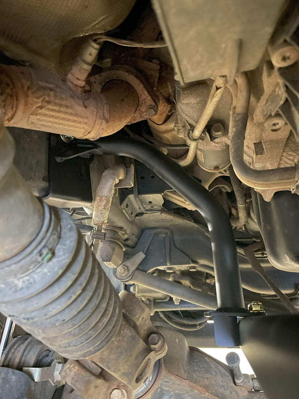 The tubular bar guard fitted alongside the exhaust and steering components