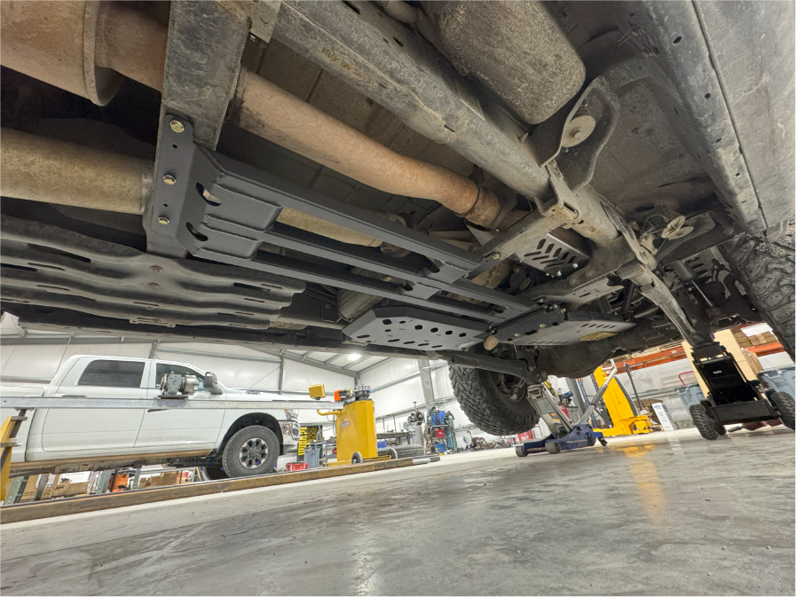 The fitted guard running back along the underbody past the exhaust