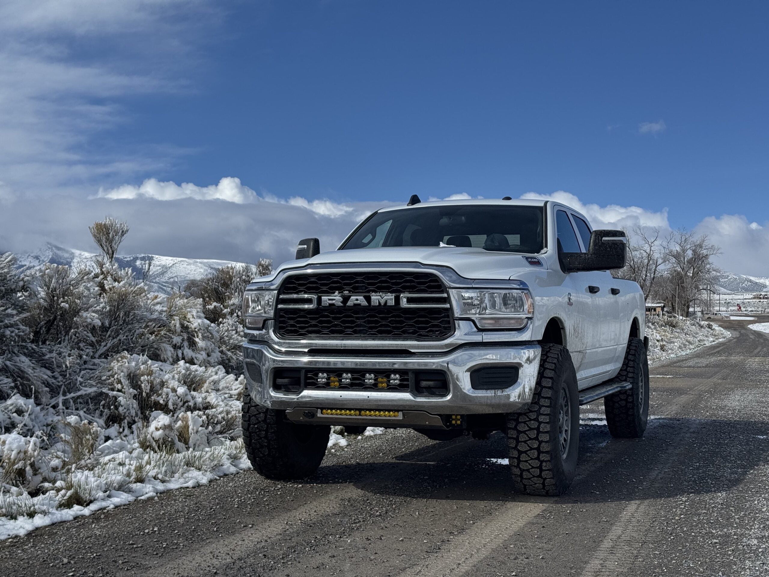 White Ram on a snowy desert road, sliders visible below the doors