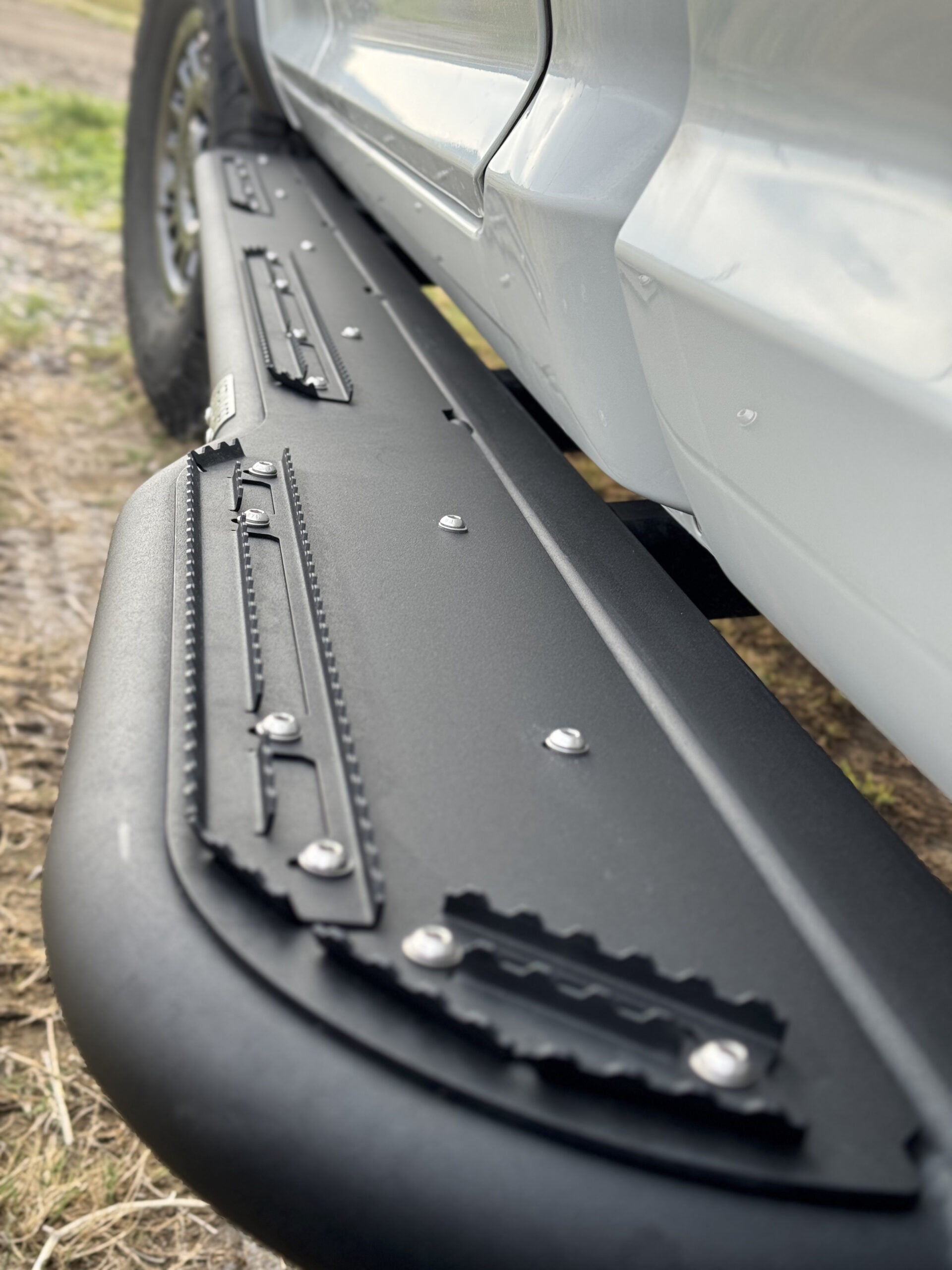 Close view down the length of the slider showing the grip strips and the end kick-up