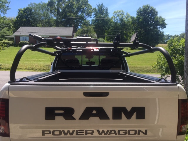 Rear view of a white Power Wagon with carriers mounted across the rack crossbars
