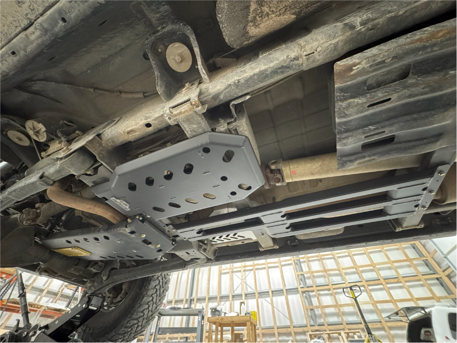 Transmission and transfer case armor installed, seen from under the truck