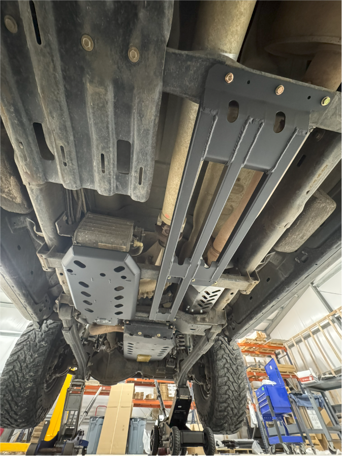 Skid plates and bar guard installed, seen from under the truck