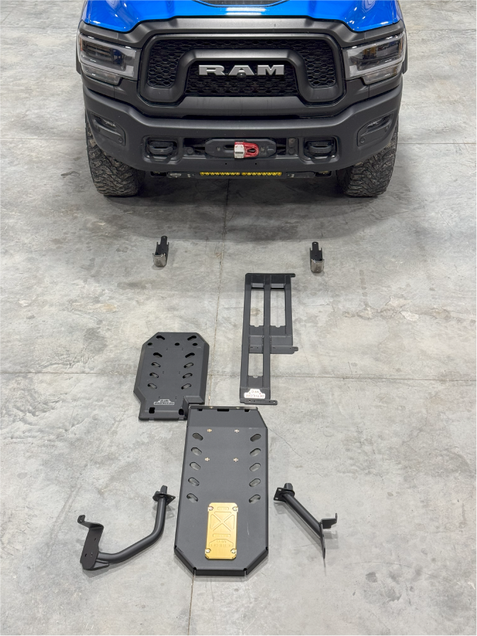 Dethloff armor kit laid out on the shop floor in front of a blue Ram 2500