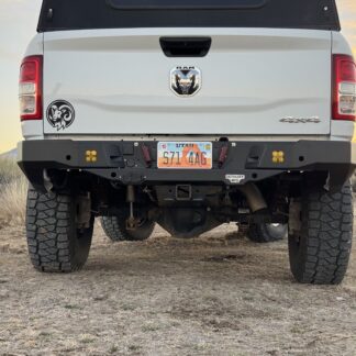 Straight-on rear view of the truck, license plate centered in the bumper and the factory tow hitch below it