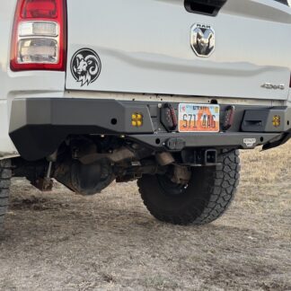 Bumper center section from behind at an angle, amber marker lights either side of the license plate