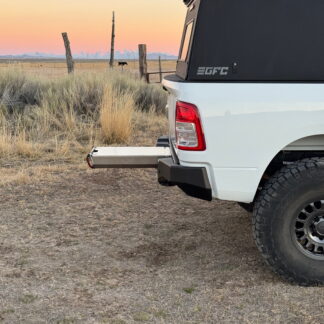 Rear corner at sunset, the drawer extended well out past the bumper
