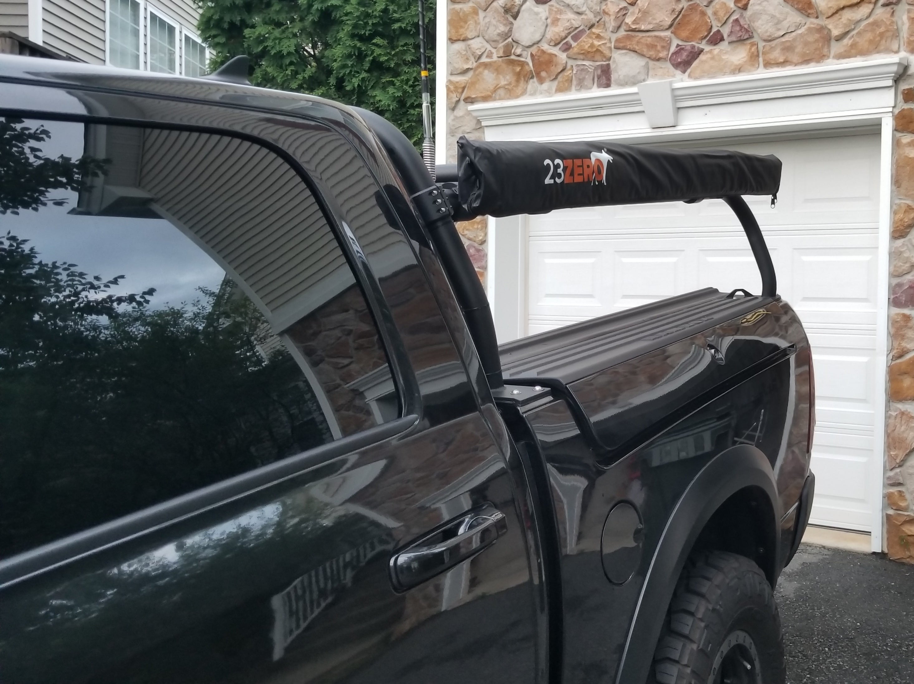 A black Ram with the awning stowed along the bedside above the tonneau