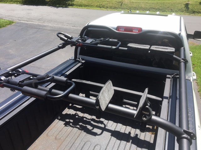 Looking down into the bed at bike carriers mounted across the rack crossbars