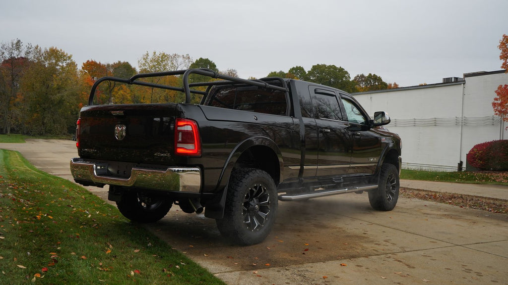 Black Ram seen from the rear quarter on a wet driveway, rack running over the bed