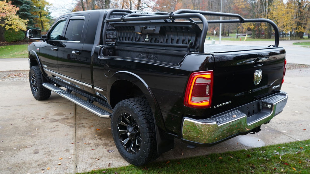 Rear quarter of the black Ram with a slotted panel mounted across the front of the rack