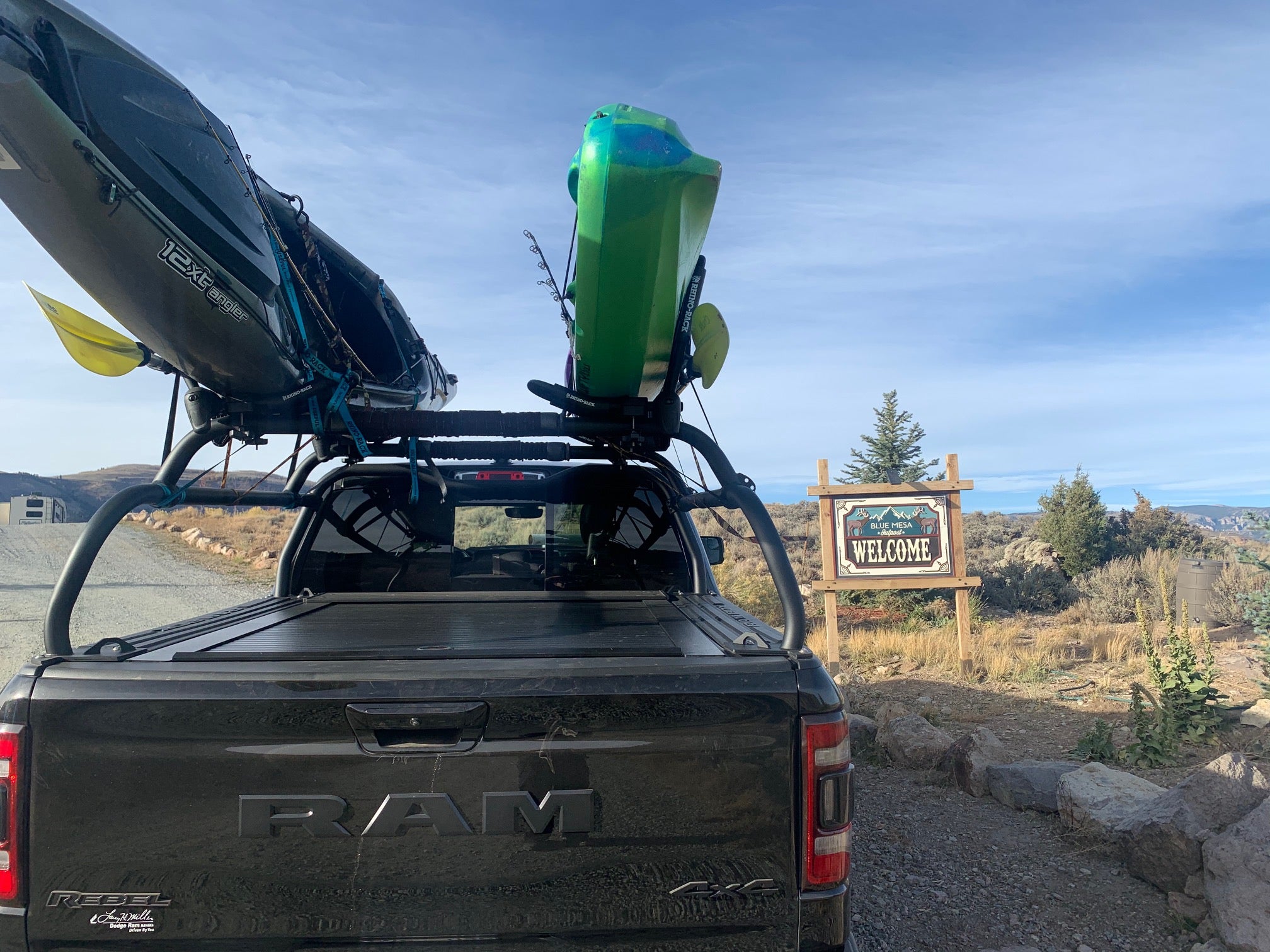 Rear view of the loaded rack: kayak overhead, water container and gear below