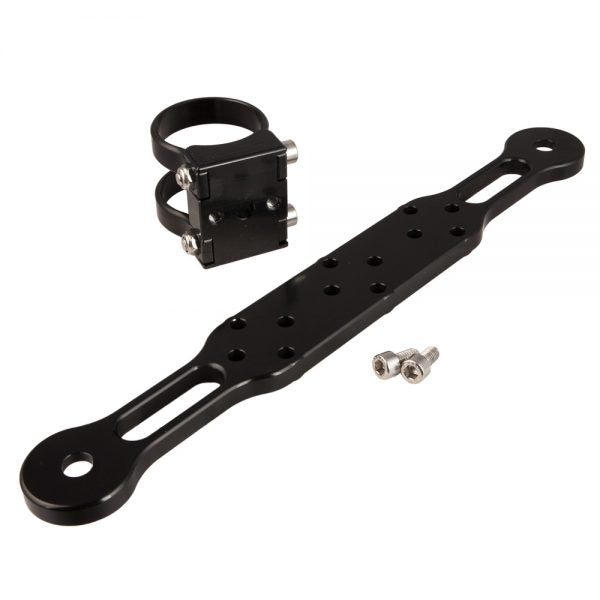 An arm, a separate clamp block and two bolts laid out together