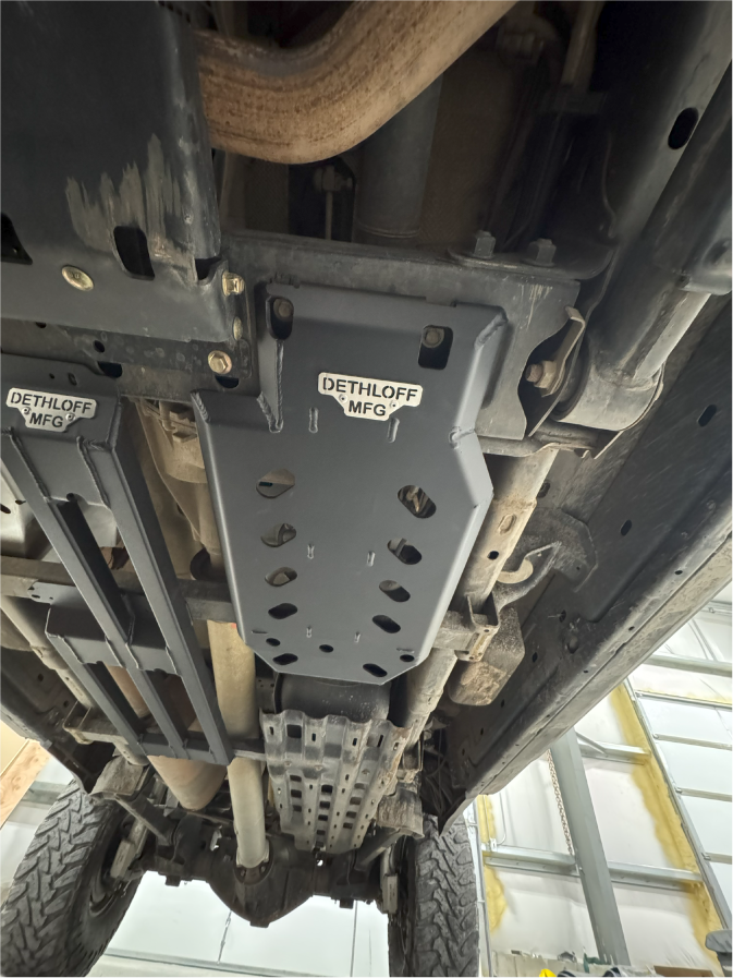 The guard fitted under the truck alongside the exhaust, seen looking up