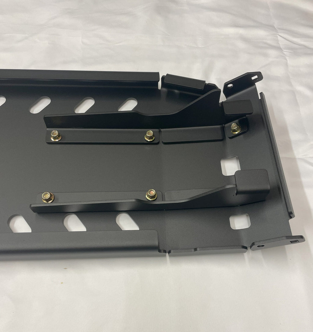 Underside of the skid plate assembly, showing the welded crossmembers and mounting tabs