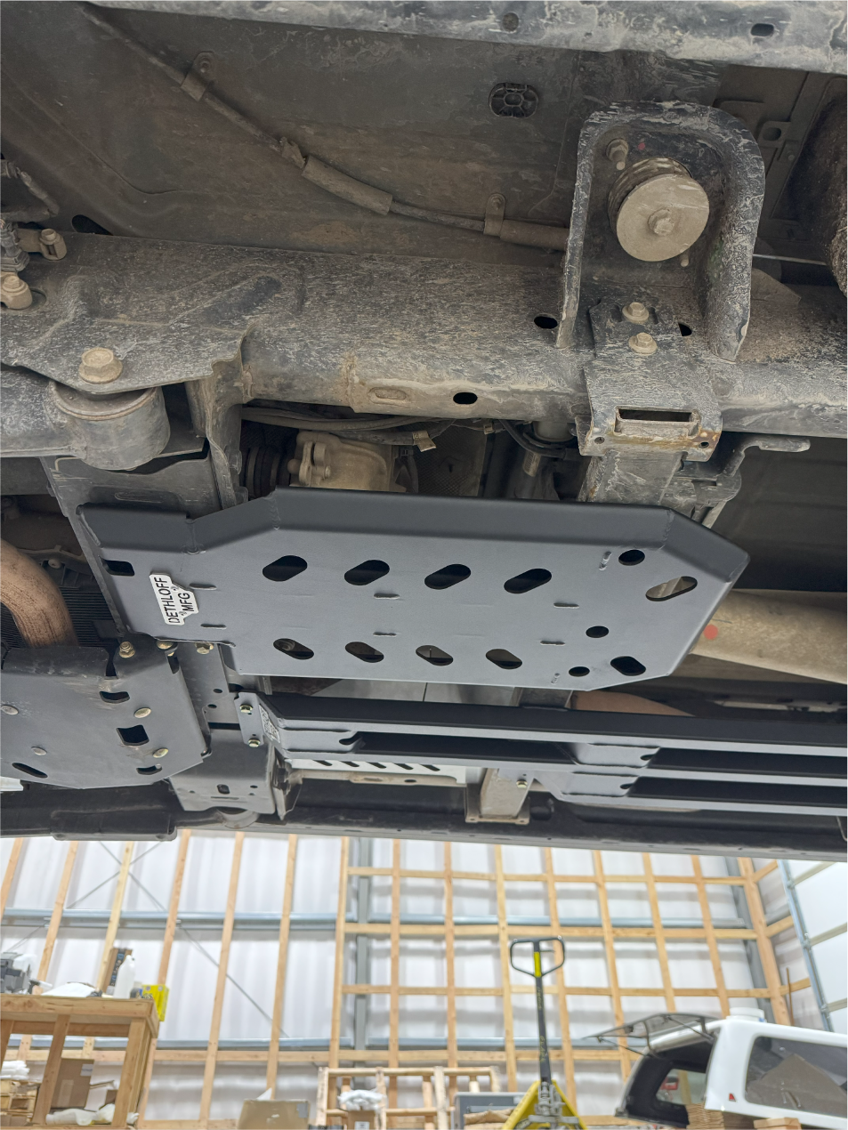 The guard fitted, seen from the side with the frame rail above it
