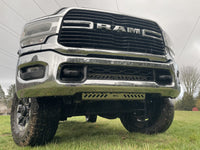 Front three-quarter of a Ram HD on wet grass, the guard visible low in the bumper opening
