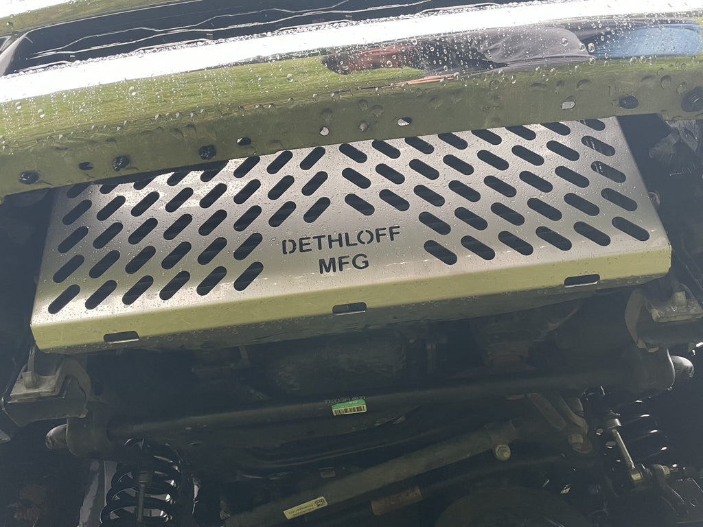 Close view of the fitted guard, DETHLOFF MFG stamped on its perforated face