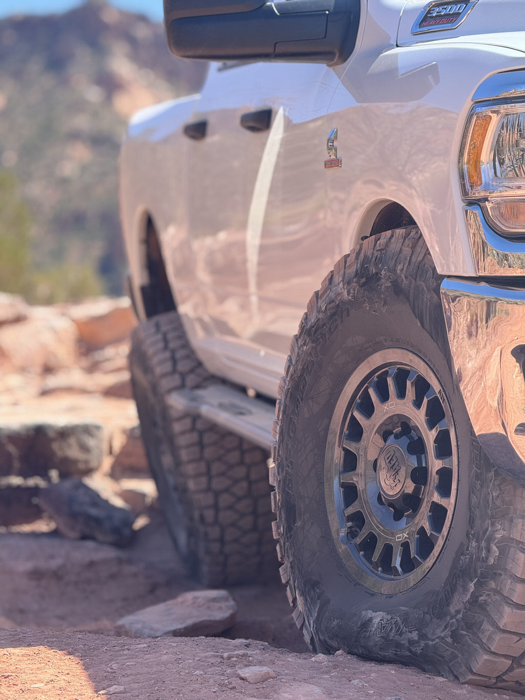 Close view of the front wheel and slider with the truck sitting up on rock