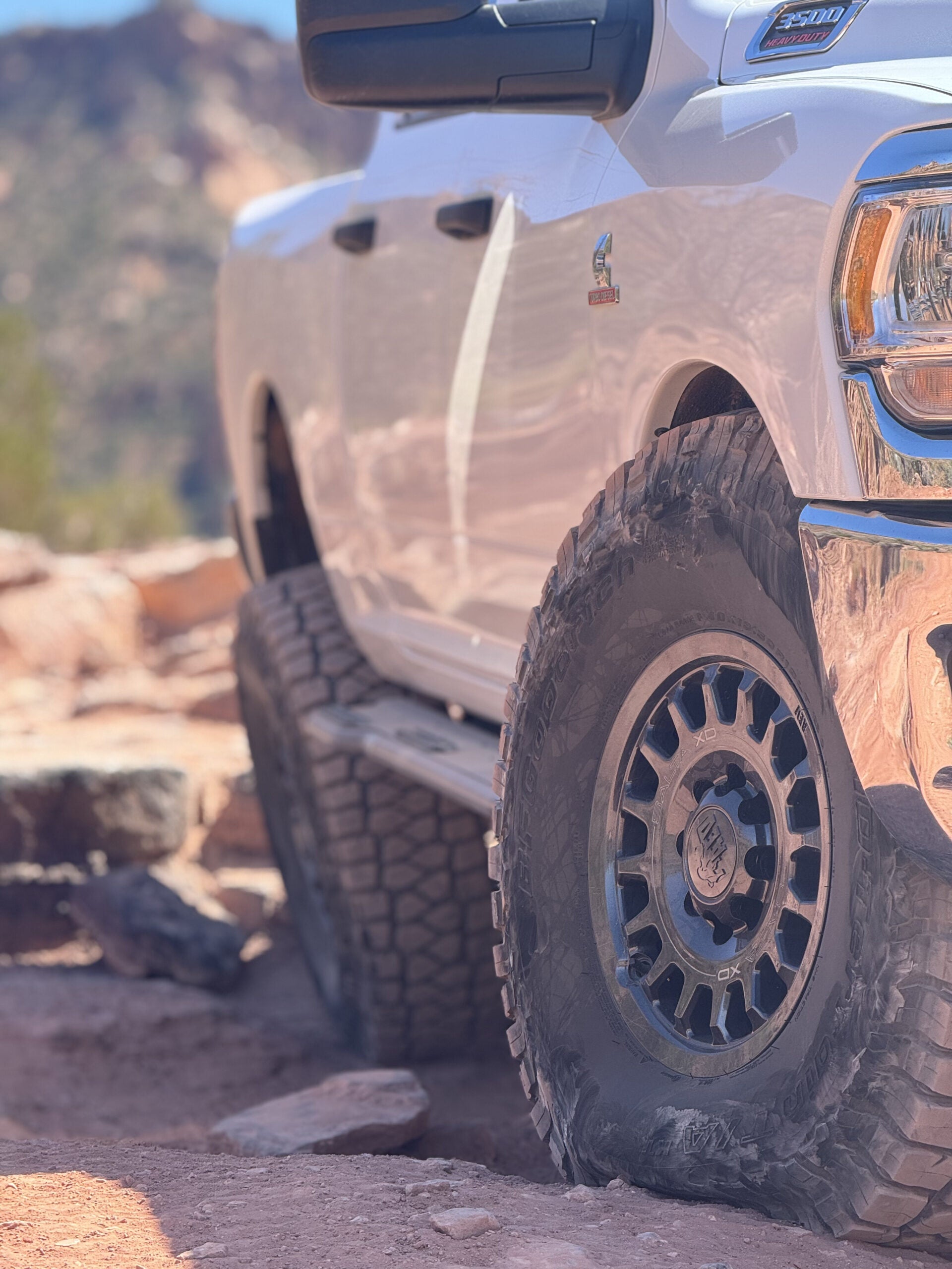 Close view of the front wheel and slider with the truck sitting up on rock