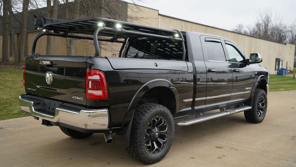 Rear quarter of the black Ram with lights mounted along the rack's upper bars