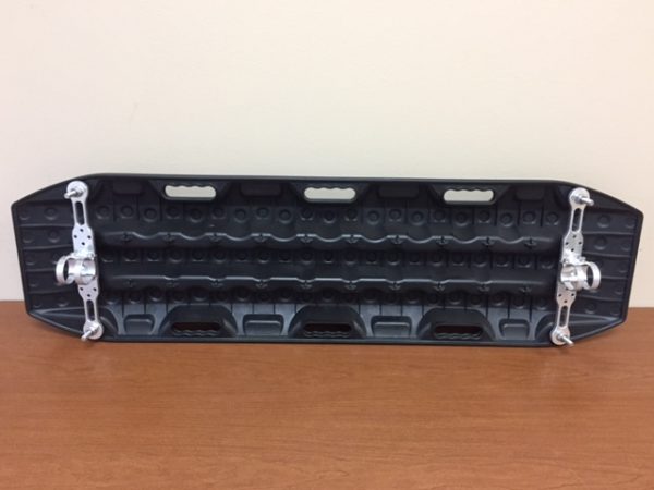 The recovery board on a table with two mounting arms clamped through it