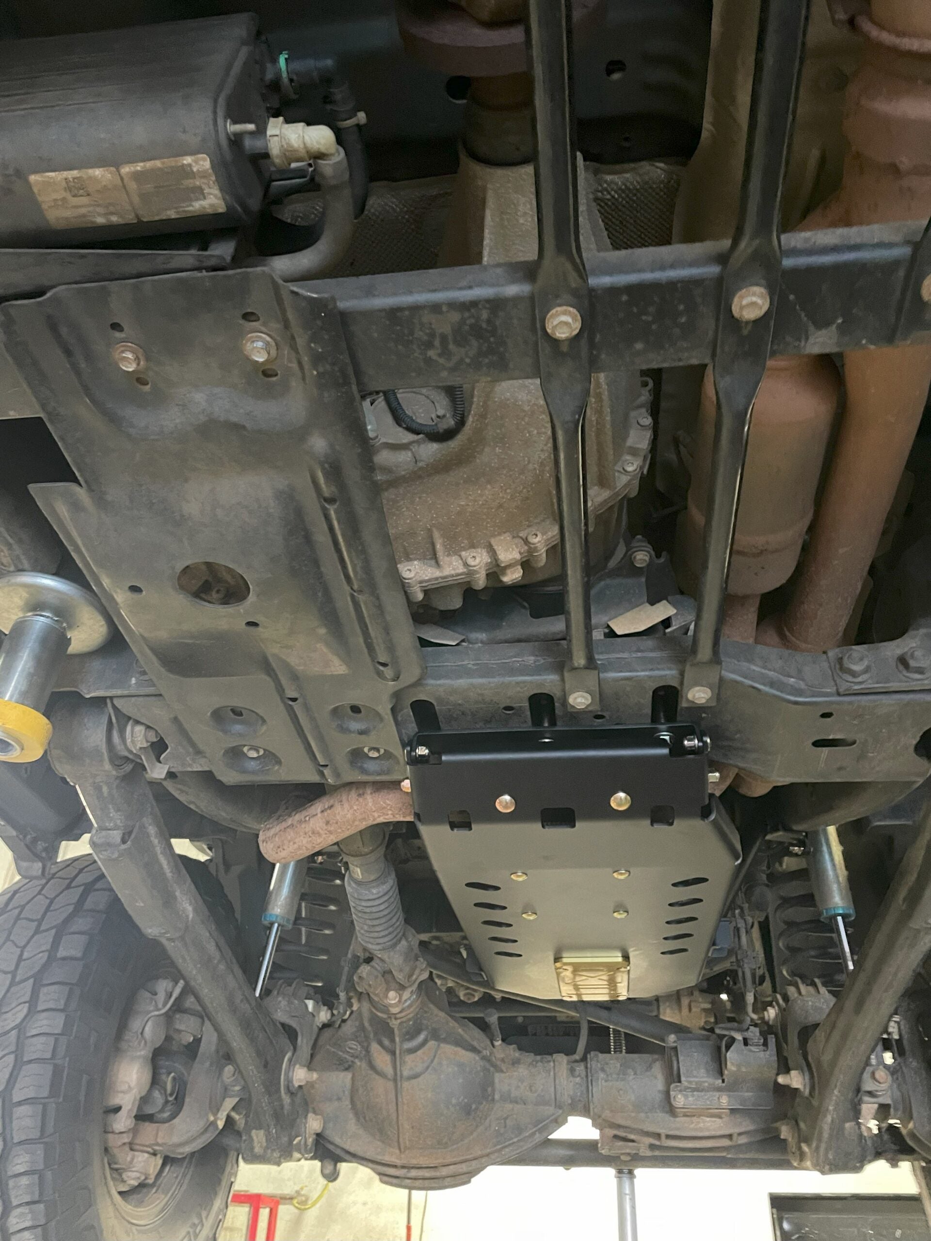 Wide view of the underside with the plate and its crossmember bracing in place