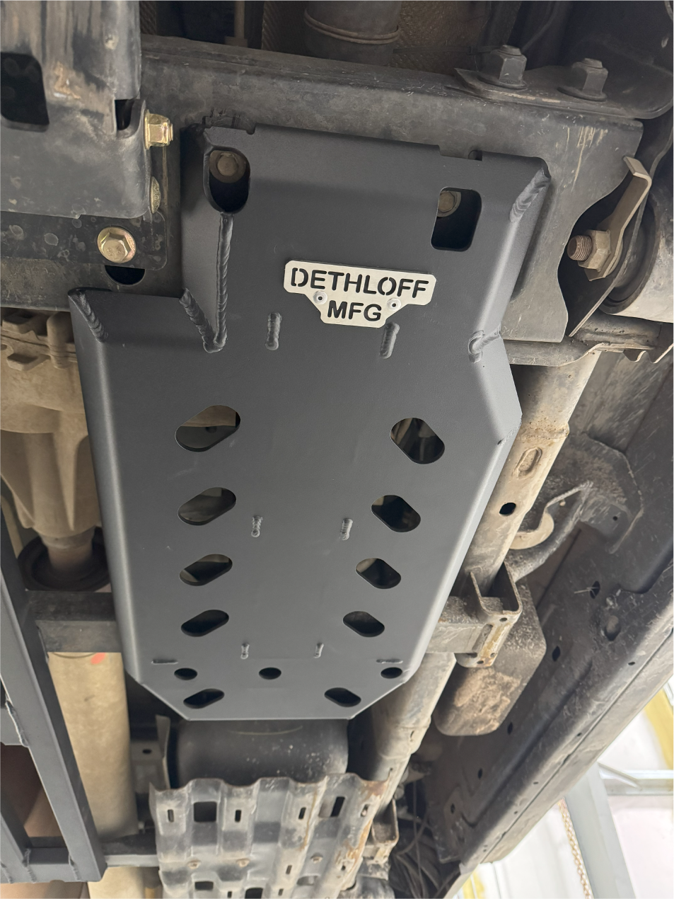 Close view of the fitted guard and its badge, bolted up under the truck