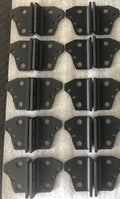 Ten black brackets laid out in rows on a foam sheet