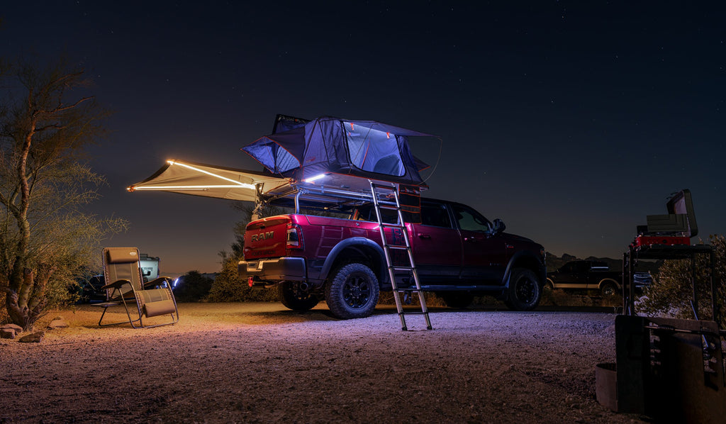 Red Ram at night, roof tent open with the ladder down and the awning extended