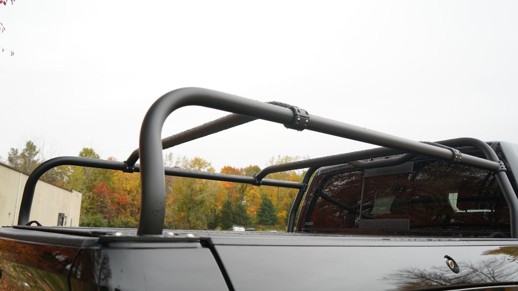 Close view of the rack's tubular hoop and a crossbar clamped to the side rail